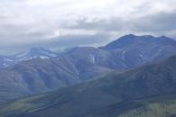 [Mountains, snow, grass, and clouds]