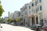 [Funky hill houses in San Francisco with Coit tower in the background]