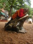 [Frank riding a bronze toad]