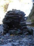 [Rock cairn by the falls (natural light)]