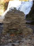 [Rock cairn by the falls (with flash)]