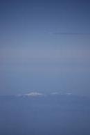 [Traffic and a snow-capped mountain]