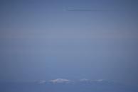 [Traffic and a snow-capped mountain]