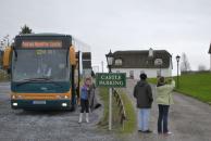 [Bus parking and another thatched roof house]