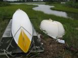 [Oarboat and canoes by the stream]